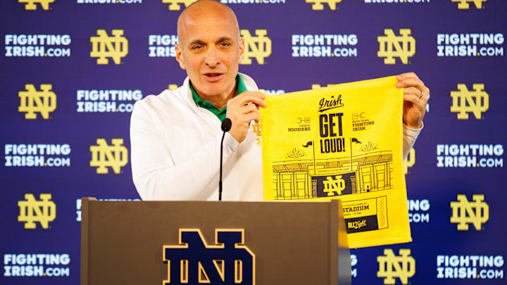 During a Dec. 17 press conference, Notre Dame Athletic Director Pete Bevacqua holds up one of the towels that will be handed out during Notre Dame football's game against Indiana in the first round of the College Football Playoff at Notre Dame Stadium on Friday, Dec. 20, 2024.