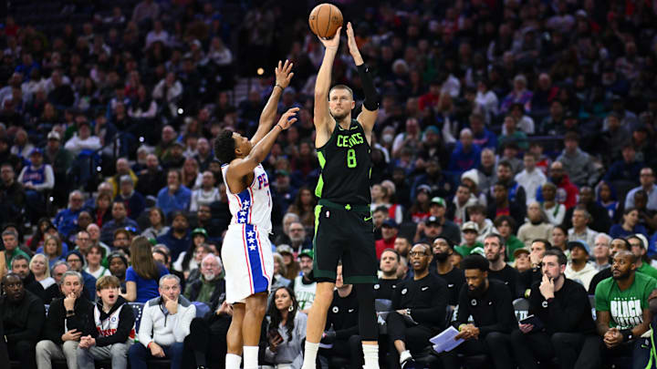 Feb 2, 2025; Philadelphia, Pennsylvania, USA; Boston Celtics forward Kristaps Porzingis (8) shoots the ball against Philadelphia 76ers guard Kyle Lowry (7) in the second quarter at Wells Fargo Center. Mandatory Credit: Kyle Ross-Imagn Images