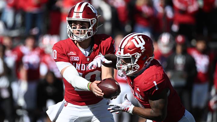 Oct 17, 2026; Bloomington, Indiana, USA;  Indiana Hoosiers quarterback Josh Hoover (10) hands off to\ running back Turbo Richard (1) during the first half against the Ohio State Buckeyes at Merchants Bank Field at Memorial Stadium.  Mandatory Credit: Robert Goddin-Imagn Images