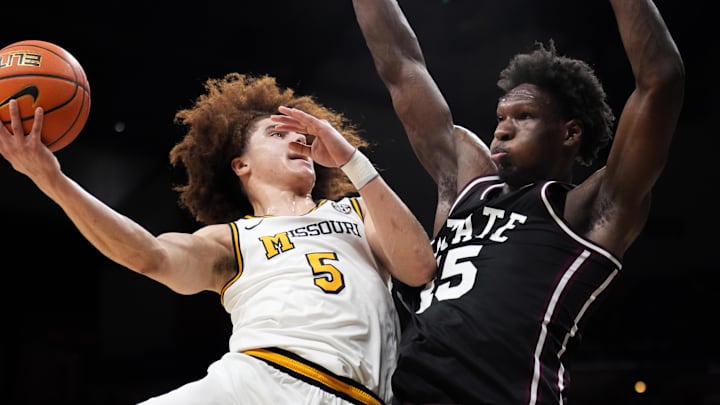 Jan 31, 2026; Columbia, Missouri, USA; Missouri Tigers guard T.O. Barrett (5) shoots as Mississippi State Bulldogs center Quincy Ballard (15) defends during the first half of the game at Mizzou Arena. Mandatory Credit: Denny Medley-Imagn Images