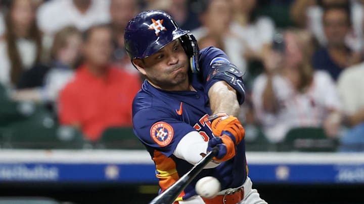 Sep 21, 2025; Houston, Texas, USA; Houston Astros second baseman Jose Altuve (27) hits an RBI single against the Seattle Mariners in the seventh inning at Daikin Park. Mandatory Credit: Thomas Shea-Imagn Images