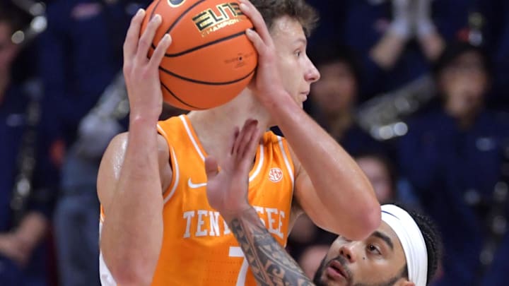Dec 14, 2024; Champaign, Illinois, USA;  Tennessee Volunteers forward Igor Milicic (7) controls the ball against Illinois Fighting Illini guard Kylan Boswell (4) during the first half at State Farm Center. Mandatory Credit: Ron Johnson-Imagn Images