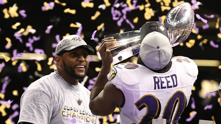 Feb 3, 2013; New Orleans, LA, USA; Baltimore Ravens safety Ed Reed (20) kisses the Vince Lombardi Trophy as linebacker Ray Lewis (left) smiles after defeating the San Francisco 49ers 34-31 in Super Bowl XLVII at the Mercedes-Benz Superdome.Mandatory Credit: Matthew Emmons-Imagn Images