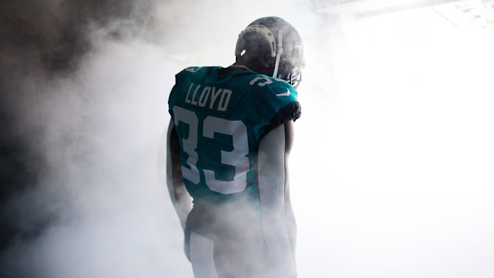 Jacksonville Jaguars linebacker Devin Lloyd (33) takes to the field through the tunnel before an NFL game. 