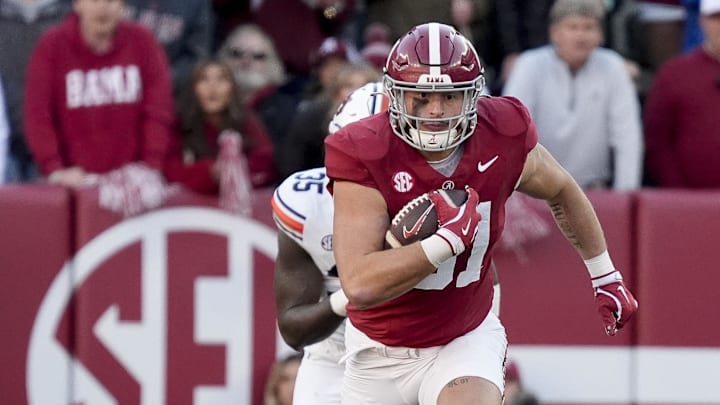 Nov 30, 2024; Tuscaloosa, Alabama, USA;  Alabama Crimson Tide tight end CJ Dippre (81) runs after a catch against Auburn Tigers buck Jalen McLeod (35) during the first half at Bryant-Denny Stadium. Mandatory Credit: Gary Cosby Jr.-Imagn Images