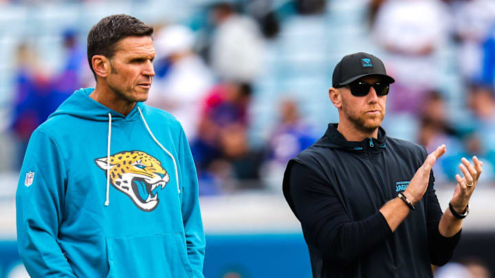 Jacksonville Jaguars Executive Vice President of Football Operations Tony Boselli, left and Jacksonville Jaguars head coach Liam Coen watch warm up before an NFL football AFC Wild Card playoff matchup, Sunday, Jan. 11, 2026, in Jacksonville, Fla. Bills lead 10-7 at the half over the Jaguars. [Doug Engle/Florida Times-Union]