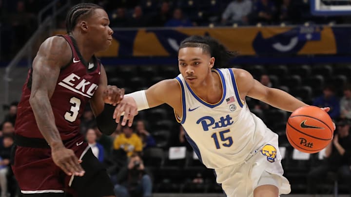 Dec 11, 2024; Pittsburgh, Pennsylvania, USA;  Pittsburgh Panthers guard Jaland Lowe (15) drives to the basket against Eastern Kentucky Colonels guard George Kimble III (3) during the first half at the Petersen Events Center. Mandatory Credit: Charles LeClaire-Imagn Images