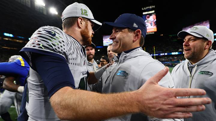 Seattle Seahawks head coach Mike MacDonald embraces quarterback Sam Darnold (14) after defeating the Los Angeles Rams. Seattle Seahawks head coach Mike MacDonald embraces quarterback Sam Darnold (14) after defeating the Los Angeles Rams.
