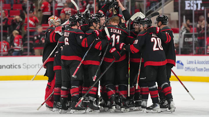 Nov 6, 2025; Raleigh, North Carolina, USA;  Carolina Hurricanes players celebrate their victory against the Minnesota Wild at Lenovo Center. Mandatory Credit: James Guillory-Imagn Images