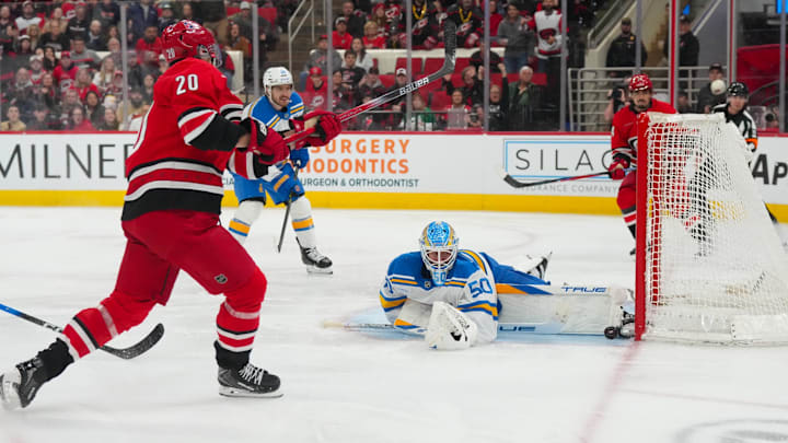 Mar 12, 2026; Raleigh, North Carolina, USA;  St. Louis Blues goaltender Jordan Binnington (50) stops the shot by Carolina Hurricanes center Sebastian Aho (20) during the third period at Lenovo Center. Mandatory Credit: James Guillory-Imagn Images