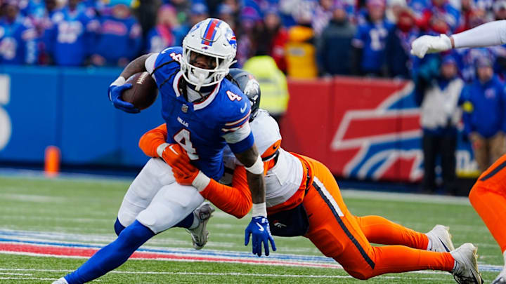 Buffalo Bills running back James Cook (4) gets taken down by Denver Broncos linebacker Dondrea Tillman (92) during the second half of the Buffalo Bills wild card game against the Denver Broncos at Highmark Stadium in Orchard Park on Jan. 12, 2025. Buffalo Bills running back James Cook (4) gets taken down by Denver Broncos linebacker Dondrea Tillman (92) during the second half of the Buffalo Bills wild card game against the Denver Broncos at Highmark Stadium in Orchard Park on Jan. 12, 2025.