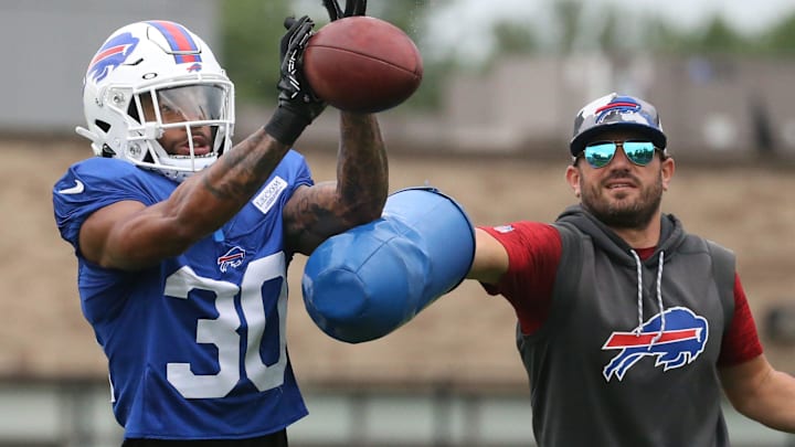 Bills cornerback Dane Jackson (30) eyes in the ball as he is hit by linebackers coach Bobby Babich