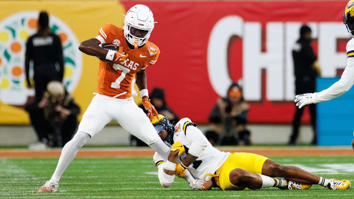 Texas Longhorns wide receiver Kaliq Lockett is tackled by Michigan Wolverines defensive end T.J. Guy during the second half 
