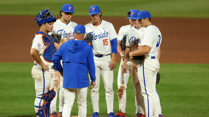 Florida head coach Kevin O'Sullivan has mound conference during a game against South Carolina.