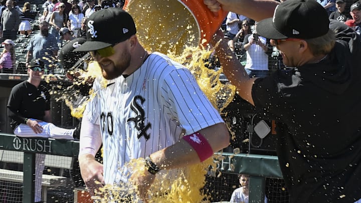 Chicago White Sox pitcher Jonathan Cannon dumps the Gatorade bucket on designated hitter Tim Elko (30) after defeating the Miami Marlins at Rate Field.