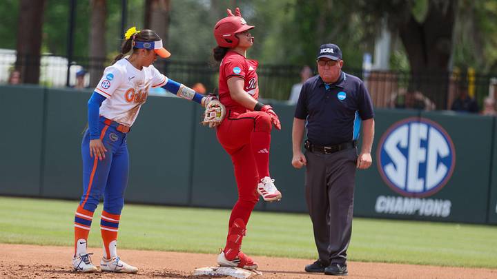 Florida infielder Gabi Comia (10) tries to tag a celebrating Texas Tech catcher Lagi Quiroga (4) during the super regional game of the NCAA Division 1 softball championship at Katie Seashole Pressly Stadium in Gainesville, FL on Friday, May 22, 2026. [Alan Youngblood/Gainesville Sun]