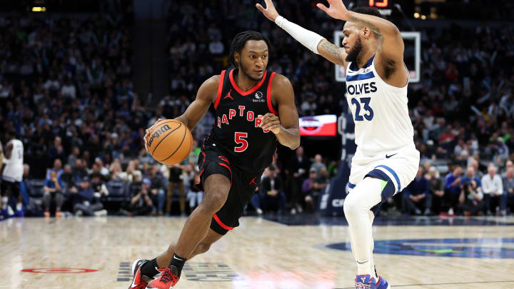 Apr 3, 2024; Minneapolis, Minnesota, USA; Toronto Raptors guard Immanuel Quickley (5) works around Minnesota Timberwolves guard Monte Morris (23) during the fourth quarter at Target Center. Mandatory Credit: Matt Krohn-USA TODAY Sports