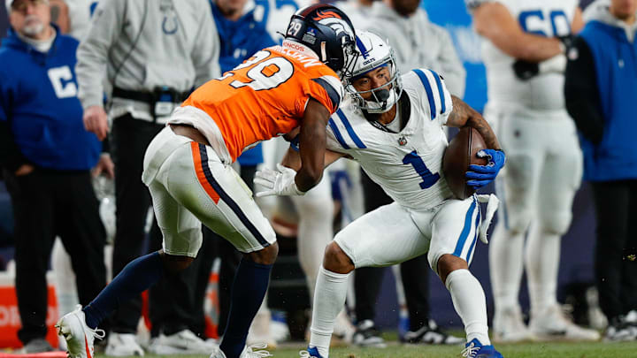 Dec 15, 2024; Denver, Colorado, USA; Indianapolis Colts wide receiver Josh Downs (1) is tackled by Denver Broncos cornerback Ja'Quan McMillian (29) in the fourth quarter at Empower Field at Mile High. Mandatory Credit: Isaiah J. Downing-Imagn Images