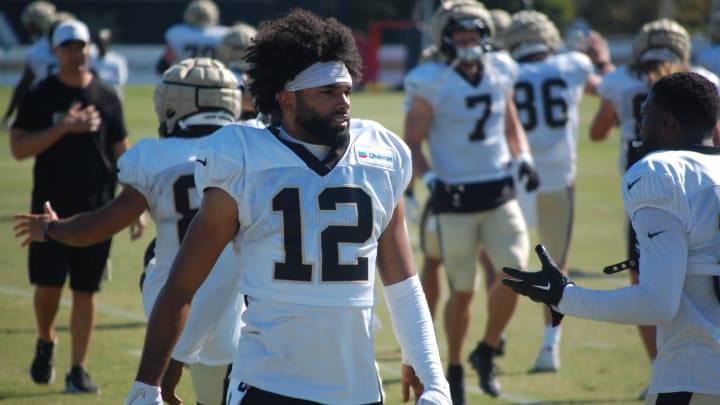 Chris Olave during stretch at Saints training camp. Chris Olave during stretch at Saints training camp.