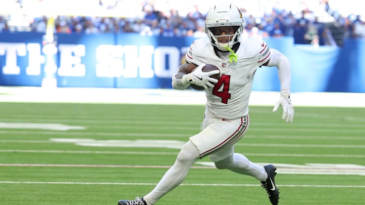 Oct 12, 2025; Indianapolis, Indiana, USA; Arizona Cardinals wide receiver Greg Dortch (4) carries the ball for a touchdown against the Arizona Cardinals during the third quarter of the game at Lucas Oil Stadium. Mandatory Credit: Trevor Ruszkowski-Imagn Images