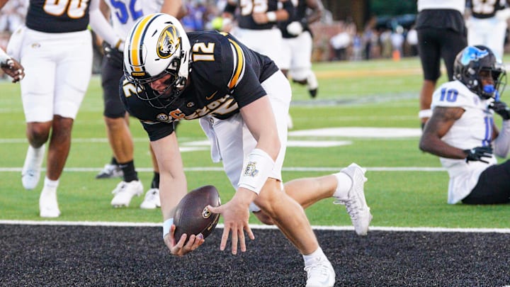 Sep 7, 2024; Columbia, Missouri, USA; Missouri Tigers quarterback Brady Cook (12) runs in for a touchdown against the Buffalo Bulls during the first half at Faurot Field at Memorial Stadium. Mandatory Credit: Denny Medley-Imagn Images Sep 7, 2024; Columbia, Missouri, USA; Missouri Tigers quarterback Brady Cook (12) runs in for a touchdown against the Buffalo Bulls during the first half at Faurot Field at Memorial Stadium. Mandatory Credit: Denny Medley-Imagn Images