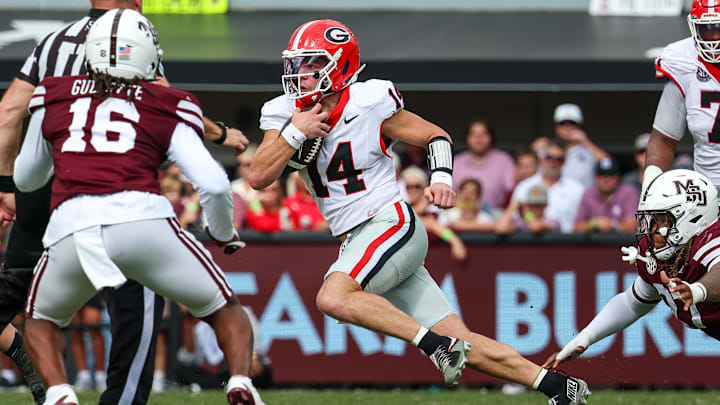 Nov 8, 2025; Starkville, Mississippi, USA; Georgia Bulldogs quarterback  Gunner Stockton (14) runs with the ball against the Mississippi State Bulldogs during the first half at Davis Wade Stadium at Scott Field. Mandatory Credit: Wesley Hale-Imagn Images