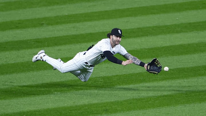 Sep 30, 2023; Chicago, Illinois, USA; Chicago White Sox left fielder Tyler Naquin (46) is unable to catch a double hit by San Diego Padres second baseman Ha-Seong Kim (7) during the sixth inning at Guaranteed Rate Field. Mandatory Credit: Kamil Krzaczynski-Imagn Images