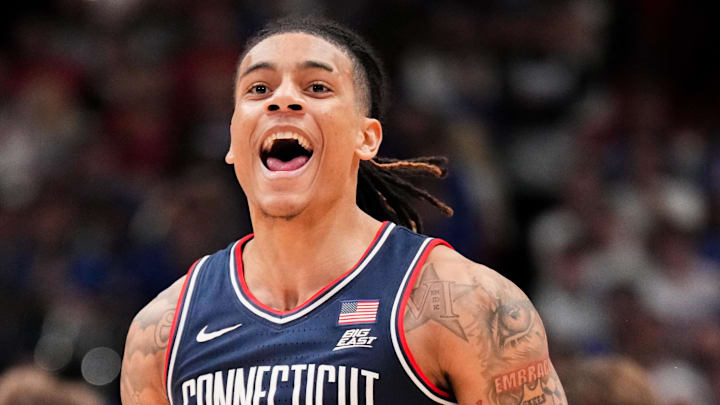 Dec 2, 2025; Lawrence, Kansas, USA; UConn Huskies guard Solo Ball (1) celebrates after scoring against the Kansas Jayhawks during the second half of the game at Allen Fieldhouse. Mandatory Credit: Denny Medley-Imagn Images