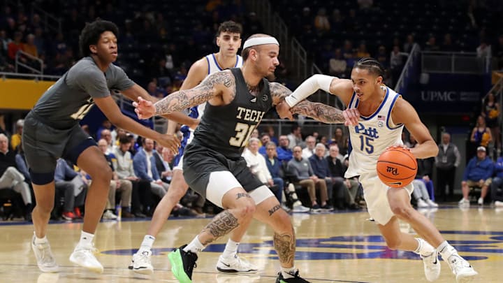 Feb 25, 2025; Pittsburgh, Pennsylvania, USA;  Pittsburgh Panthers guard Jaland Lowe (15) dribbles against Georgia Tech Yellow Jackets forward Duncan Powell (31) during the first half at the Petersen Events Center. Mandatory Credit: Charles LeClaire-Imagn Images