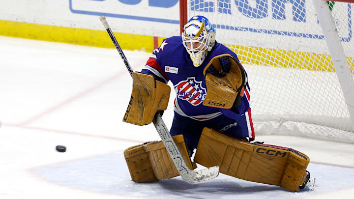 Rochester goalie Devon Levi makes the save on this shot against Laval .