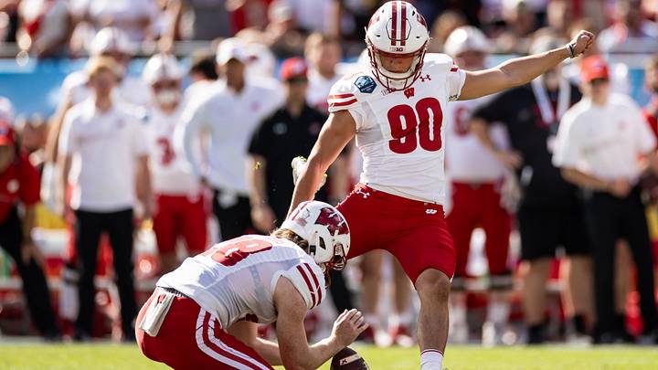 Jan 1, 2024; Tampa, FL, USA; Wisconsin Badgers punter Gavin Meyers (28) holds the ball for Wisconsin Badgers place kicker Nathanial Vakos (90) during the first half against the LSU Tigers at Raymond James Stadium. Mandatory Credit: Matt Pendleton-USA TODAY Sports