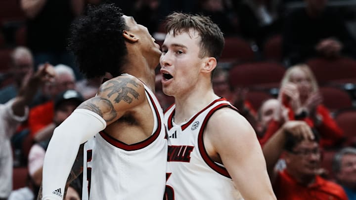 Louisville's Terrence Edwards Jr. (5) got a chest bump from teammate Reyne Smith (6) after Edwards hit a tough shot against Morehead State's Dieonte Miles (23) during their game at the KFC Yum! Center in Louisville, Ky. on Nov. 4, 2024.
