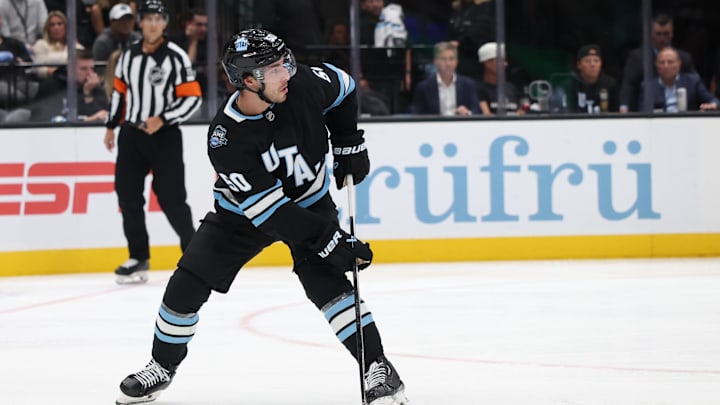 Oct 8, 2024; Salt Lake City, Utah, USA; Utah Hockey Club defenseman Sean Durzi (50) looks to pass against the Chicago Blackhawks during the third period at Delta Center. Mandatory Credit: Rob Gray-Imagn Images