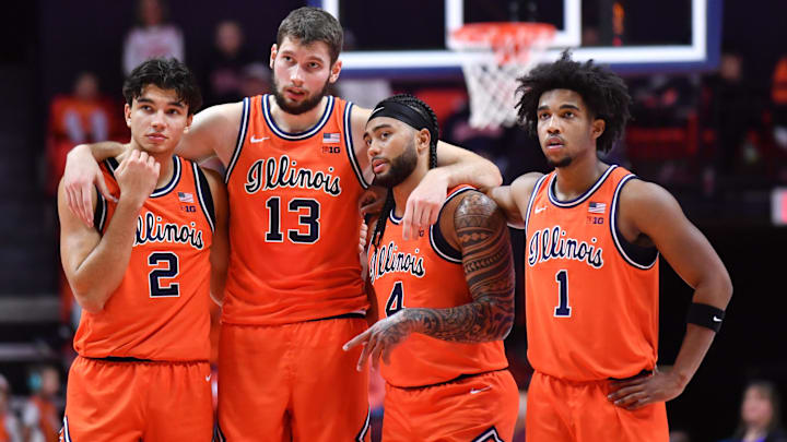 Nov 22, 2025; Champaign, Illinois, USA;  Illinois fighting Illini players  Andrej Stojakovic (2) Tomislav Ivisic (13)  guard Kylan Boswell (4) and Brandon Lee (1) stand while teammate  Ben Humrichhous (3) shoots for a technical foul on the Long Island University Sharks during the first half at State Farm Center. Mandatory Credit: Ron Johnson-Imagn Images