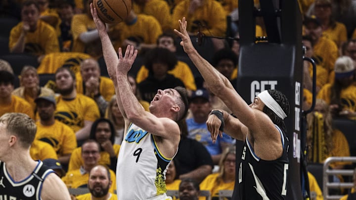 Apr 19, 2025; Indianapolis, Indiana, USA;  Indiana Pacers guard T.J. McConnell (9) shoots the ball while Milwaukee Bucks center Jericho Sims (00) defends in the first half at Gainbridge Fieldhouse. Mandatory Credit: Trevor Ruszkowski-Imagn Images