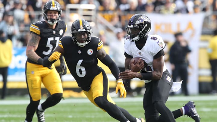 Nov 17, 2024; Pittsburgh, Pennsylvania, USA;  Baltimore Ravens quarterback Lamar Jackson (8) runs the ball against Pittsburgh Steelers linebacker Patrick Queen (6) during the first quarter at Acrisure Stadium. Mandatory Credit: Charles LeClaire-Imagn Images