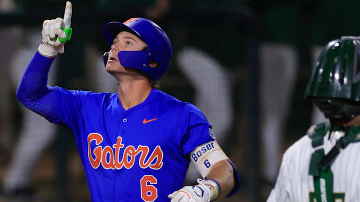 Florida utility Bobby Boser (6) points skyward after a three-run home run passing by Jacksonville catcher Nick DeLisi (38) during the fifth inning of an NCAA baseball matchup Monday, Feb. 17, 2025 at Jacksonville University in Jacksonville, Fla. Florida defeated Jacksonville 10-4. [Corey Perrine/Florida Times-Union]