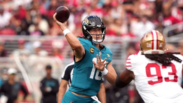 Sep 28, 2025; Santa Clara, California, USA; Jacksonville Jaguars quarterback Trevor Lawrence (center) throws a pass against San Francisco 49ers defensive tackle Kalia Davis (93) during the second quarter at Levi's Stadium. Mandatory Credit: Darren Yamashita-Imagn Images