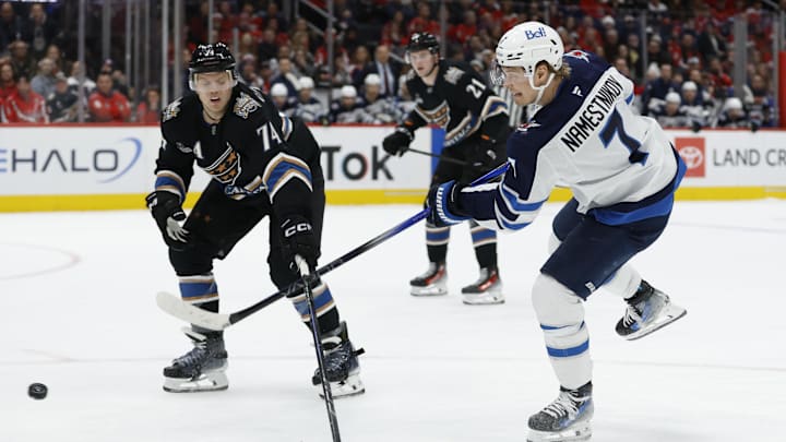 Feb 1, 2025; Washington, District of Columbia, USA; Winnipeg Jets center Vladislav Namestnikov (7) shoots the puck as Washington Capitals defenseman John Carlson (74) defends in the second period at Capital One Arena. Mandatory Credit: Geoff Burke-Imagn Images