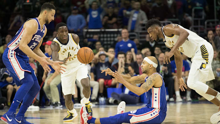 Nov 3, 2017; Philadelphia, PA, USA; Philadelphia 76ers guard Jerryd Bayless (0) passes the ball to 76ers guard Ben Simmons (25) in front of Indiana Pacers forward Thaddeus Young (21) and guard Victor Oladipo (4) during the fourth quarter at Wells Fargo Center. Mandatory Credit: Bill Streicher-Imagn Images