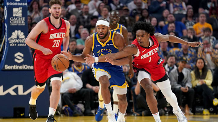 Apr 6, 2025; San Francisco, California, USA; Golden State Warriors guard Moses Moody (4) dribbles the ball next to Houston Rockets forward Amen Thompson (1) in the first quarter at the Chase Center. Mandatory Credit: Cary Edmondson-Imagn Images