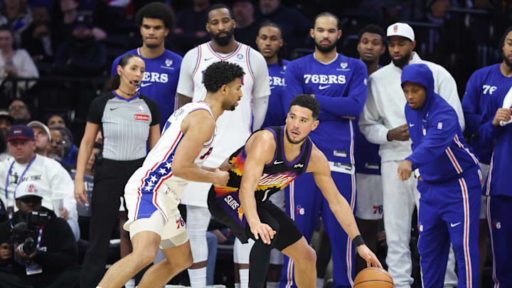 Jan 20, 2026; Philadelphia, Pennsylvania, USA; Phoenix Suns guard Devin Booker (1) dribbles the ball against Philadelphia 76ers guard Quentin Grimes (5) during the fourth quarter at Xfinity Mobile Arena. Mandatory Credit: Bill Streicher-Imagn Images