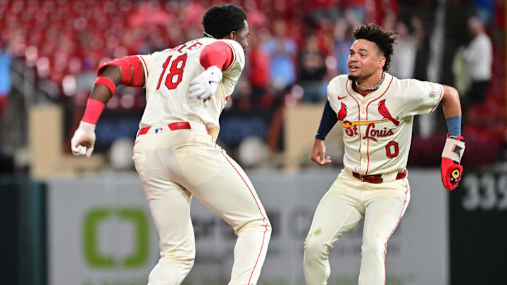 Sep 6, 2025; St. Louis, Missouri, USA;  St. Louis Cardinals outfielder Jordan Walker (18, left) and St. Louis Cardinals shortstop Masyn Winn (0) celebrate their 3-2 win over the San Francisco Giants after Walker doubled to left, scoring Winn and teammate St. Louis Cardinals second baseman Garrett Hampson (not shown) in the bottom of the ninth inning at Busch Stadium. Mandatory Credit: Tim Vizer-Imagn Images