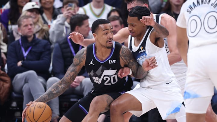 Feb 28, 2025; Salt Lake City, Utah, USA; Utah Jazz forward John Collins (20) dribbles the ball against Minnesota Timberwolves guard Rob Dillingham during the second half at Delta Center. Mandatory Credit: Rob Gray-Imagn Images