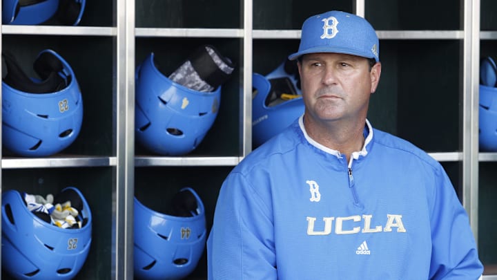 Jun 24, 2013; Omaha, NE, USA; UCLA Bruins head coach John Savage (22) looks on in the dugout before game 1 of the College World Series finals against the Mississippi State Bulldogs at TD Ameritrade Park. Mandatory Credit: Bruce Thorson-Imagn Images