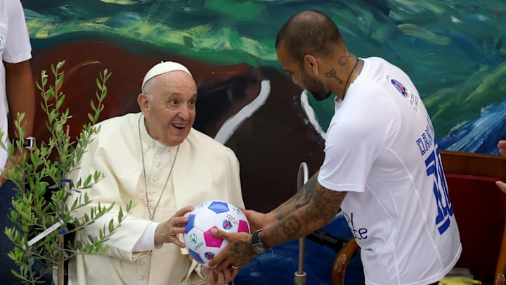 Pope Francis accepts a ball from Dani Alves, a former soccer fullback who starred for Barcelona and Brazil, at a 2022 ceremony celebrating Scholas Occurrentes, an international educational program for youth. Francis, from Argentina, was famously a soccer fan and devoted to CA San Lorenzo de Almagro.