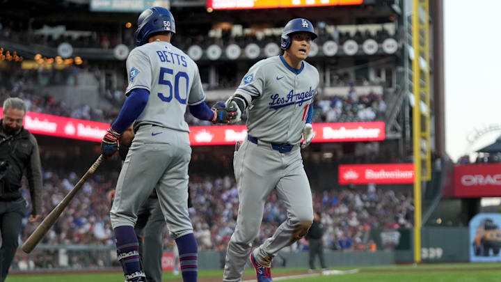 Sep 13, 2025; San Francisco, California, USA; Los Angeles Dodgers designated hitter Shohei Ohtani (17) is congratulated by shortstop Mookie Betts (50) after hitting a home run against the San Francisco Giants in the third inning at Oracle Park. Mandatory Credit: Cary Edmondson-Imagn Images