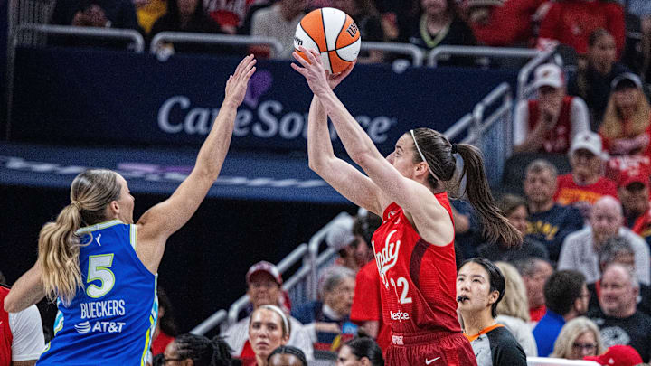 May 9, 2026; Indianapolis, Indiana, USA; Indiana Fever guard Caitlin Clark (22) shoots the ball while Dallas Wings guard Paige Bueckers (5) defends in the second half at Gainbridge Fieldhouse. Mandatory Credit: Trevor Ruszkowski-Imagn Images