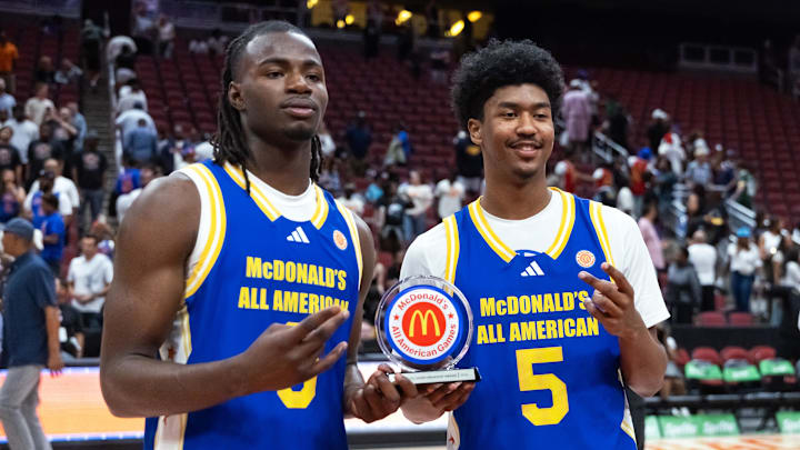 Mar 31, 2026; Glendale, AZ, USA; Caleb Holt (3) and Jason Crowe Jr (5) celebrate with the player of the game trophy following the McDonalds All American Boys Game at Desert Diamond Arena.