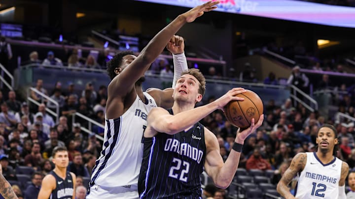 Feb 21, 2025; Orlando, Florida, USA; Orlando Magic forward Franz Wagner (22) is fouled by Memphis Grizzlies forward Jaren Jackson Jr. (13) during the second quarter at Kia Center. Mandatory Credit: Mike Watters-Imagn Images